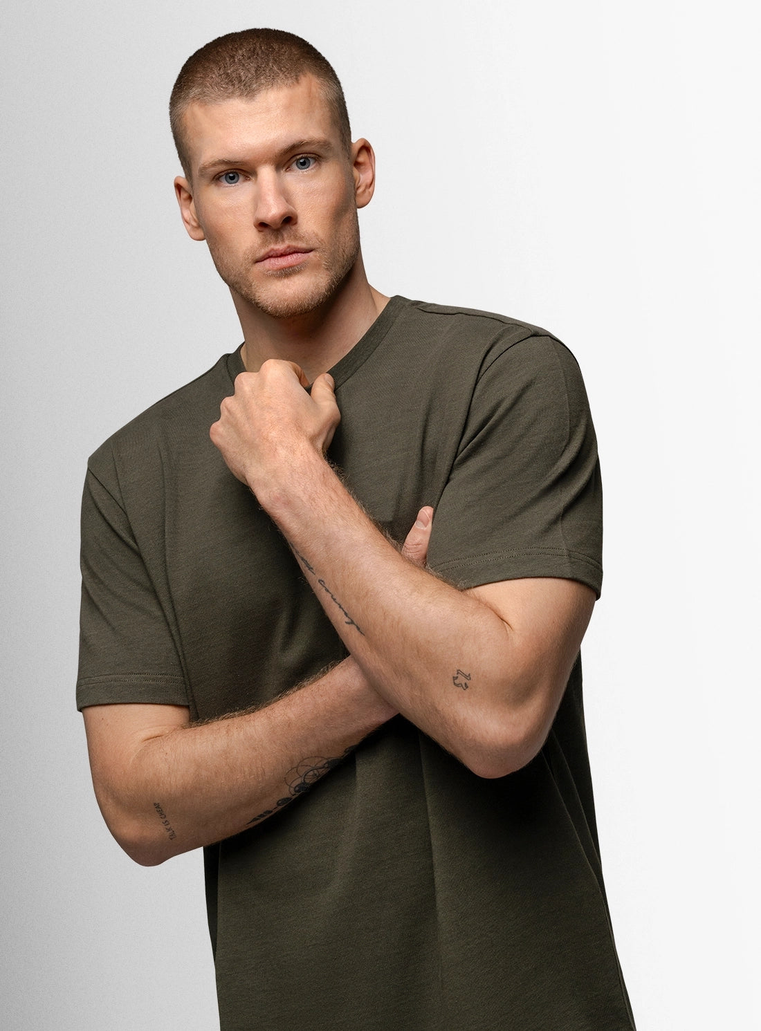 Man wearing a green t-shirt against a plain background