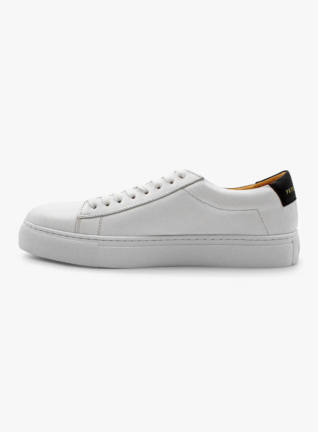 White sneaker with a black heel tab on a white background