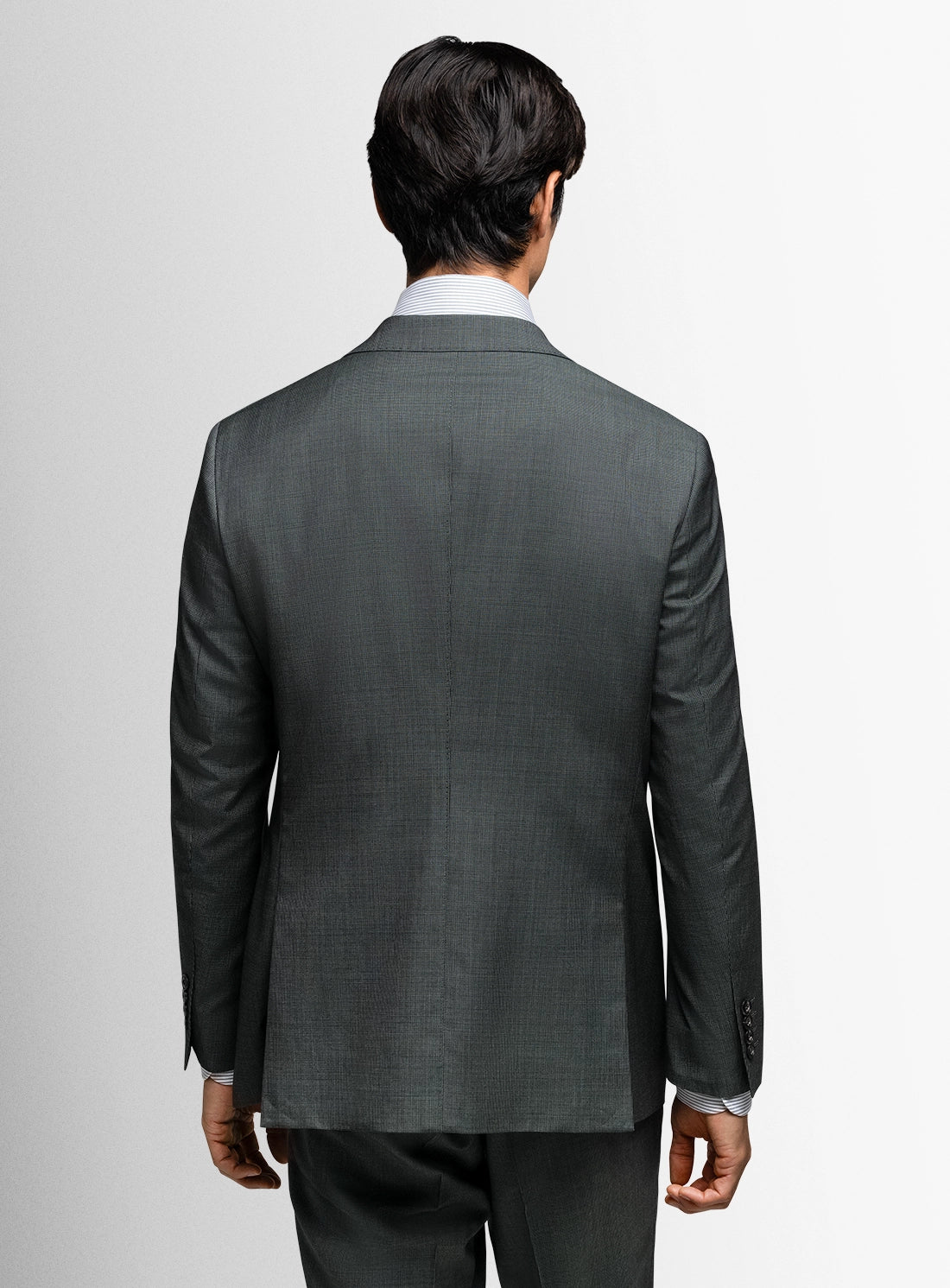 Gray suit jacket worn by a person on a light gray background