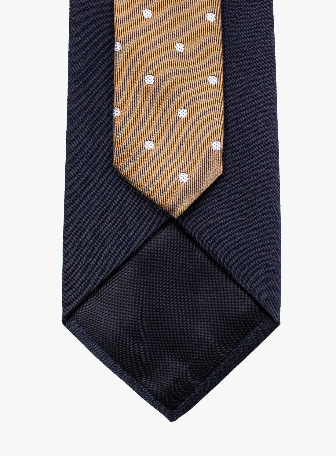Navy blue tie with a gold and white polka dot pattern on a white background