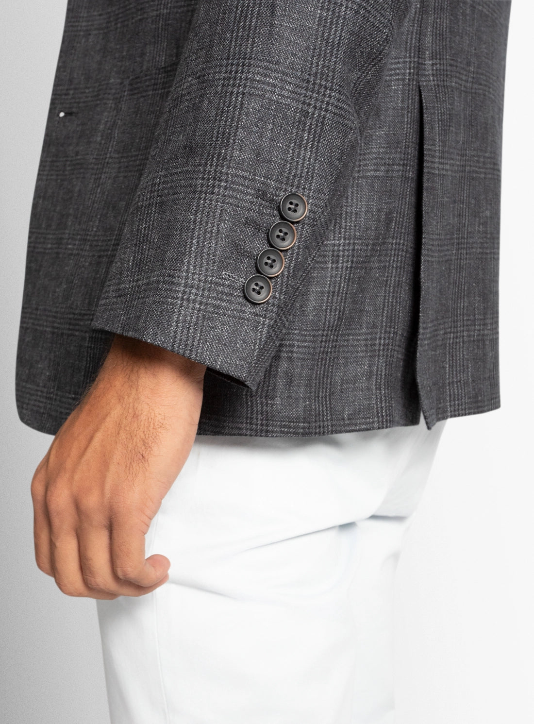 Gray checkered blazer with three buttons on a plain background