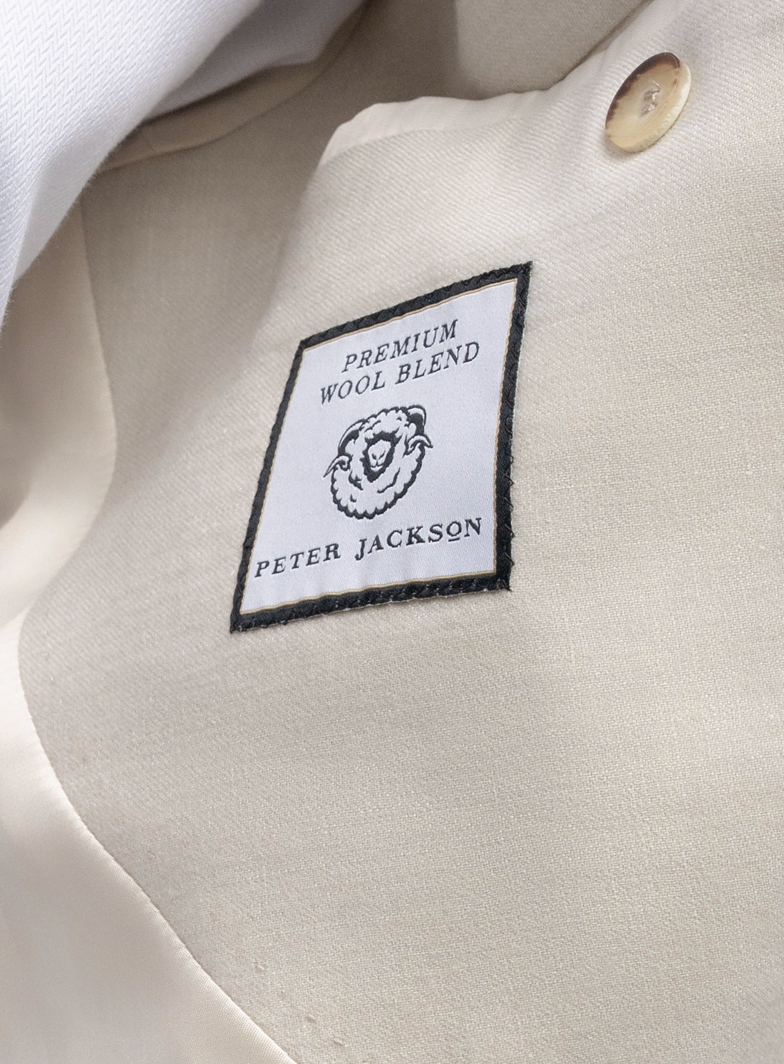 Label on a garment indicating 'Premium Wool Blend' by Peter Jackson.