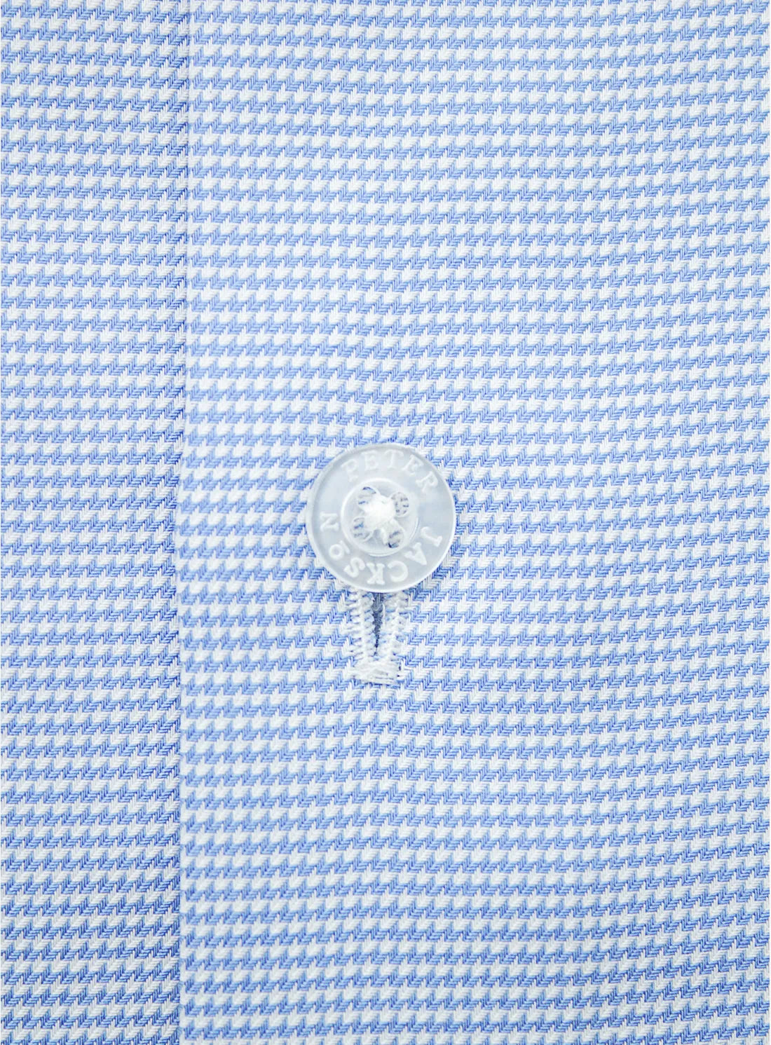 Blue dress shirt with a Peter Jackson label on a white background