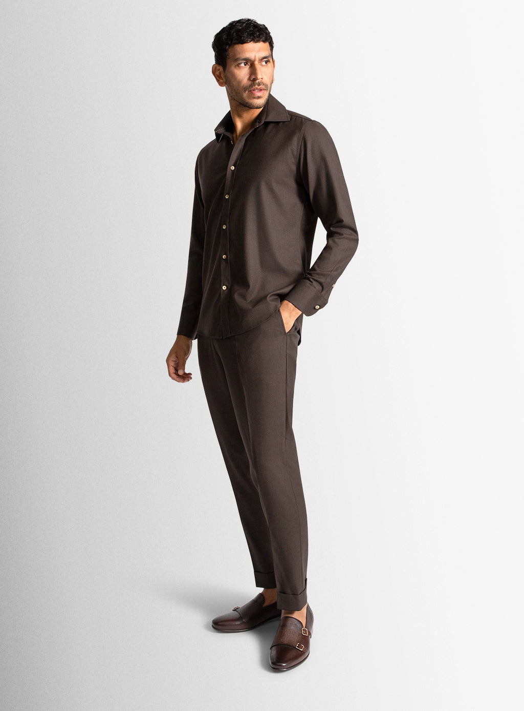 Man wearing a brown suit on a light gray background