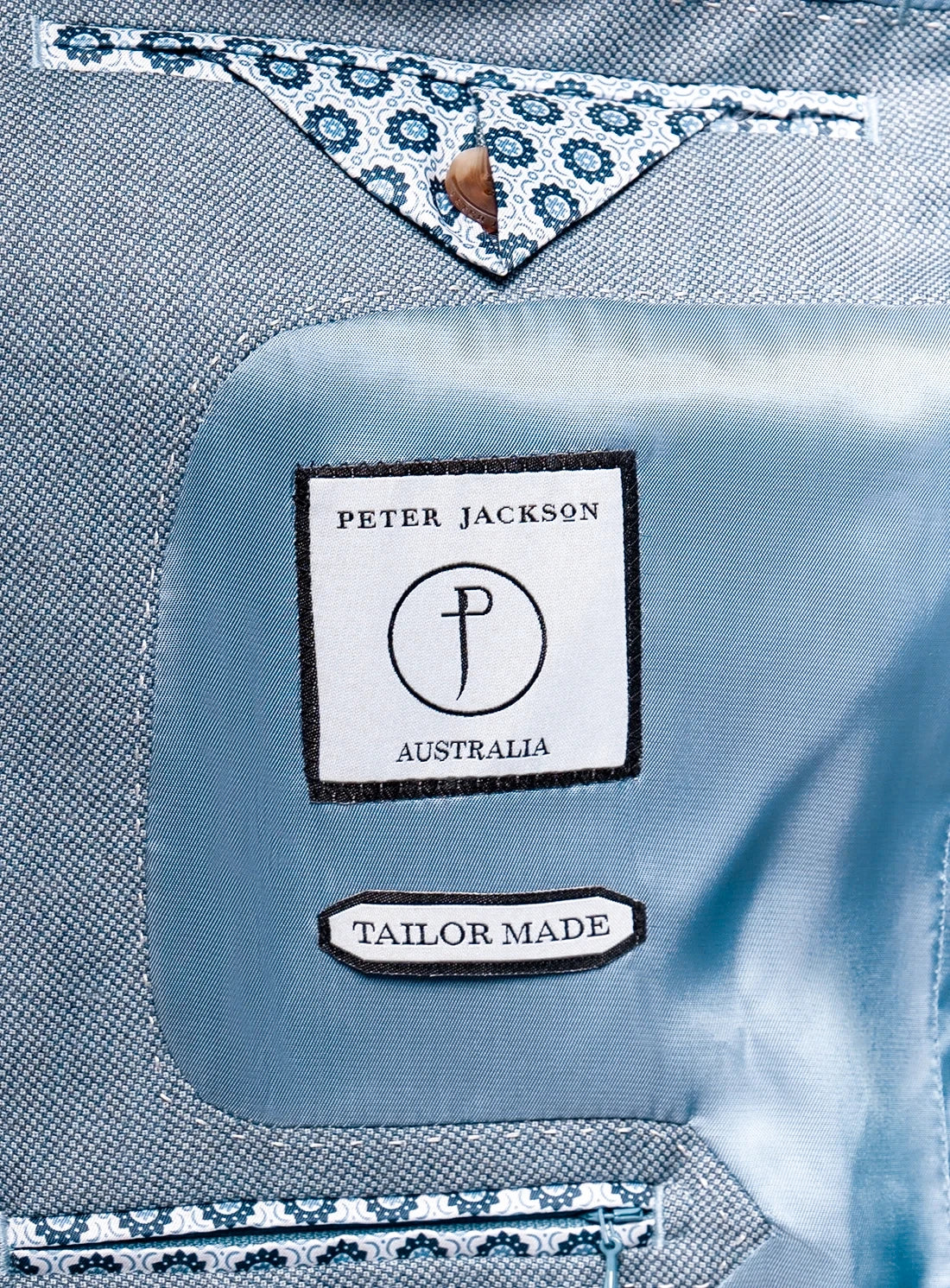 Close-up of a blue shirt with 'Peter Jackson Australia' label and 'Tailor Made' text.
