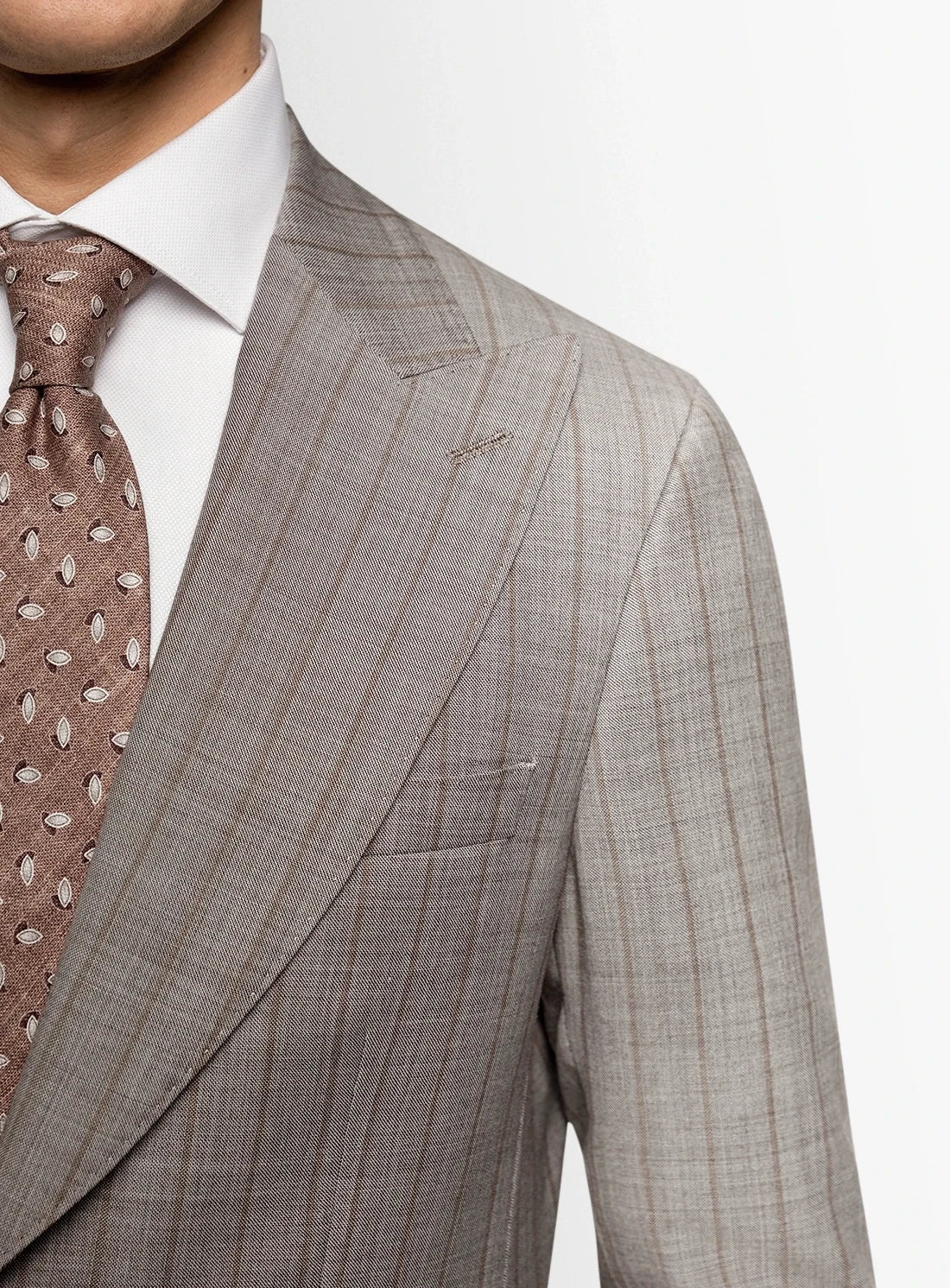 Gray checkered suit jacket with a patterned tie on a white background