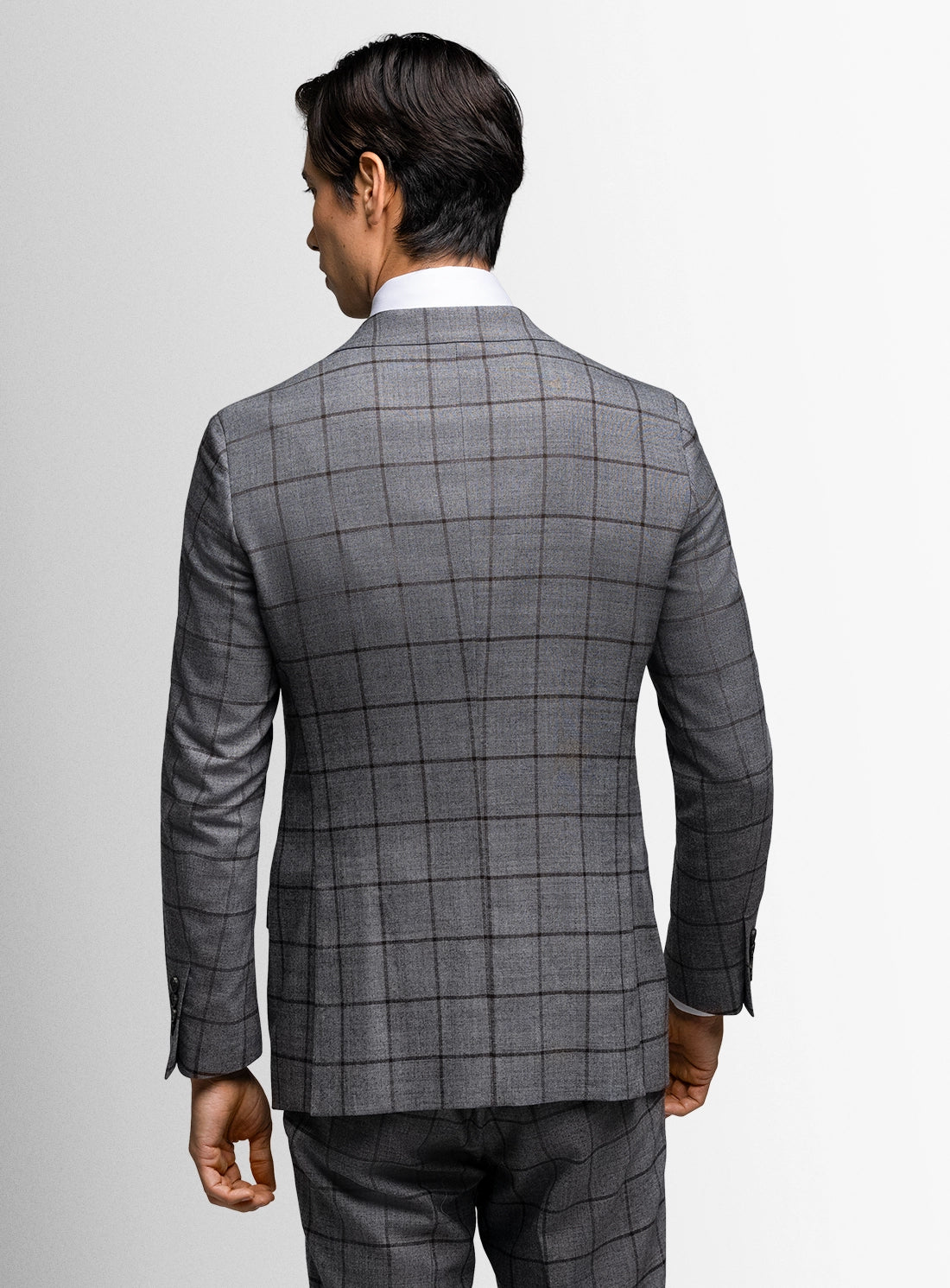 Gray checkered suit jacket worn by a person on a light gray background
