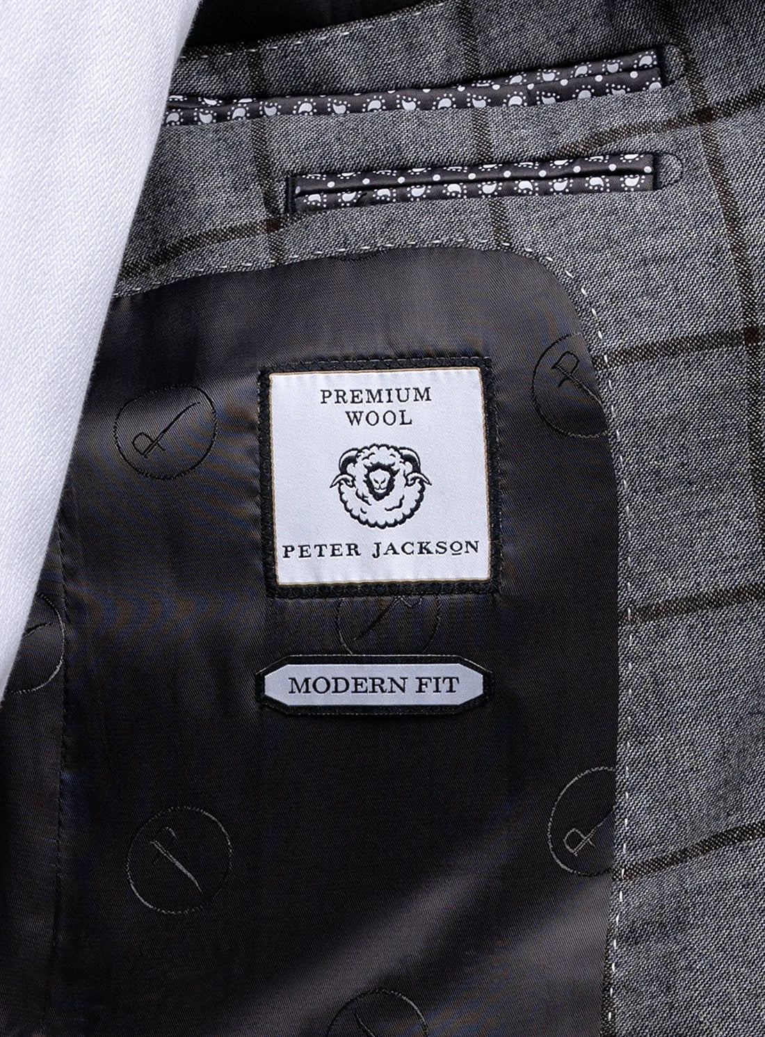 Close-up of a Peter Jackson label on a gray checkered fabric