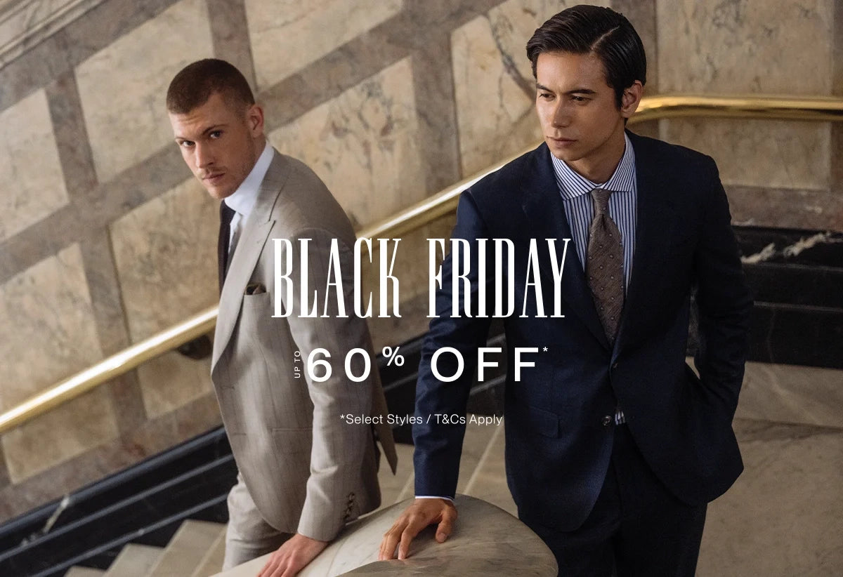 Two men in suits with Black Friday sale text in an elegant interior setting