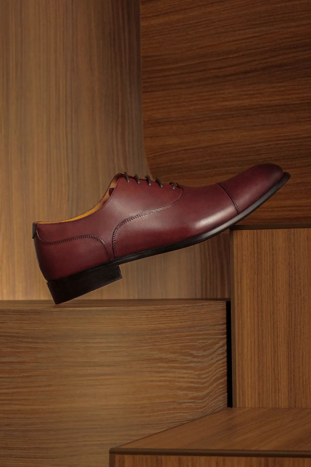 Derby shoe sitting over a wooden box