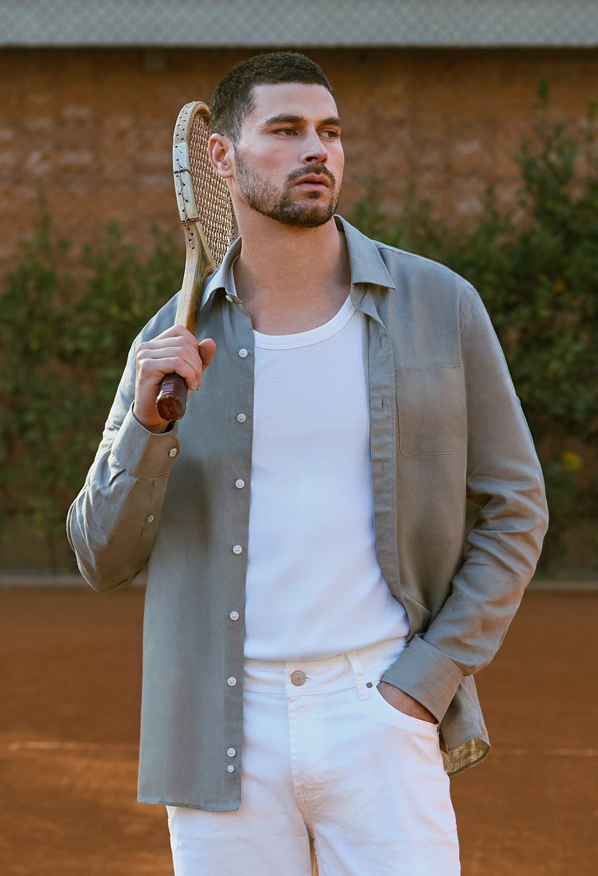 Man holding a tennis racket on a tennis court