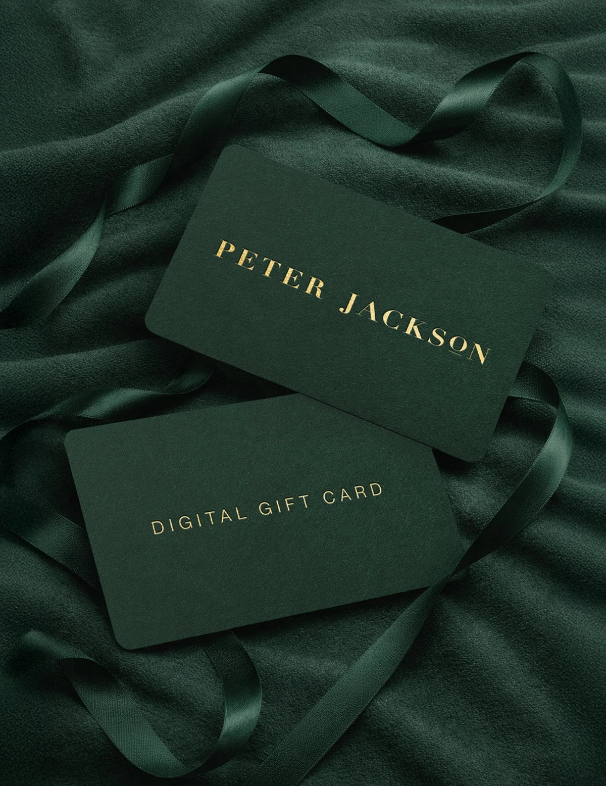 Two dark green digital gift cards with 'Peter Jackson' branding on a dark green fabric background.