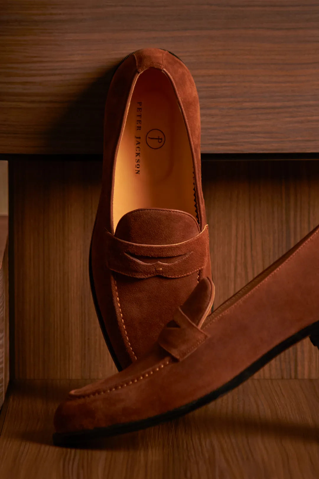 Penny loafer sitting over wooden boxes