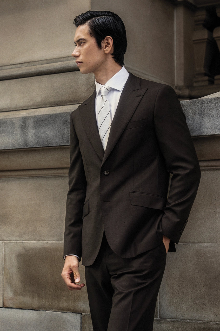 Man in a brown suit with white shirt and tie
