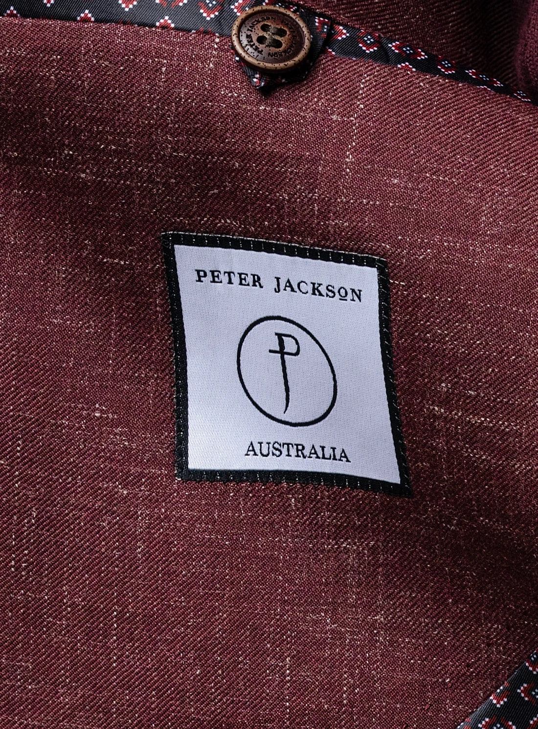 Close-up of a Peter Jackson Australia label on a textured fabric background
