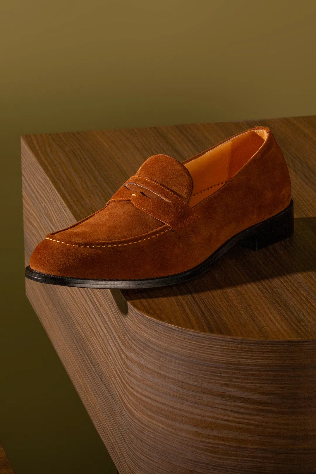A shoe sitting over a wooden box
