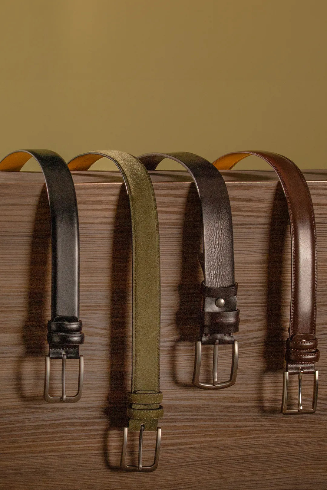 Belts sitting over a wooden box