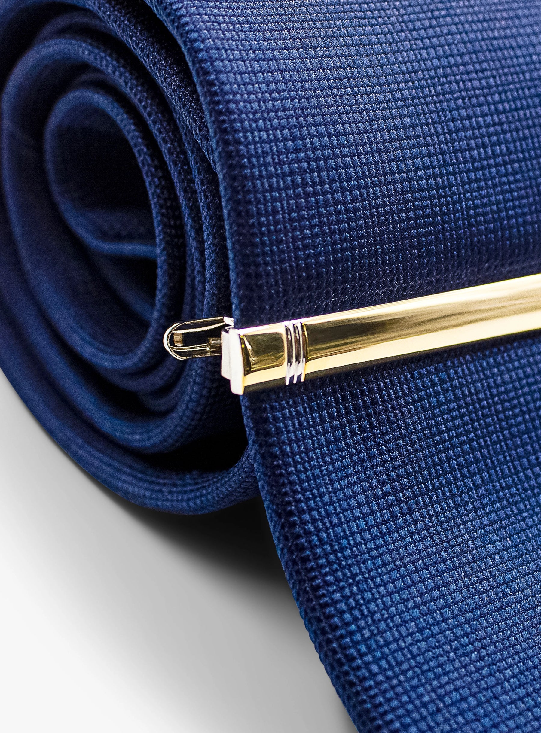 gold detailed tie bar on tie