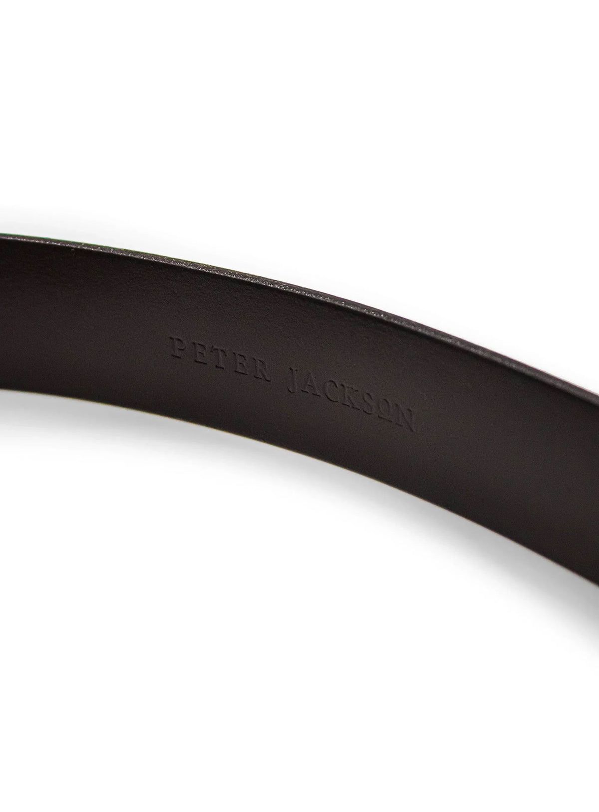 Close-up of a brown belt with 'Peter Jackson' branding on a white background
