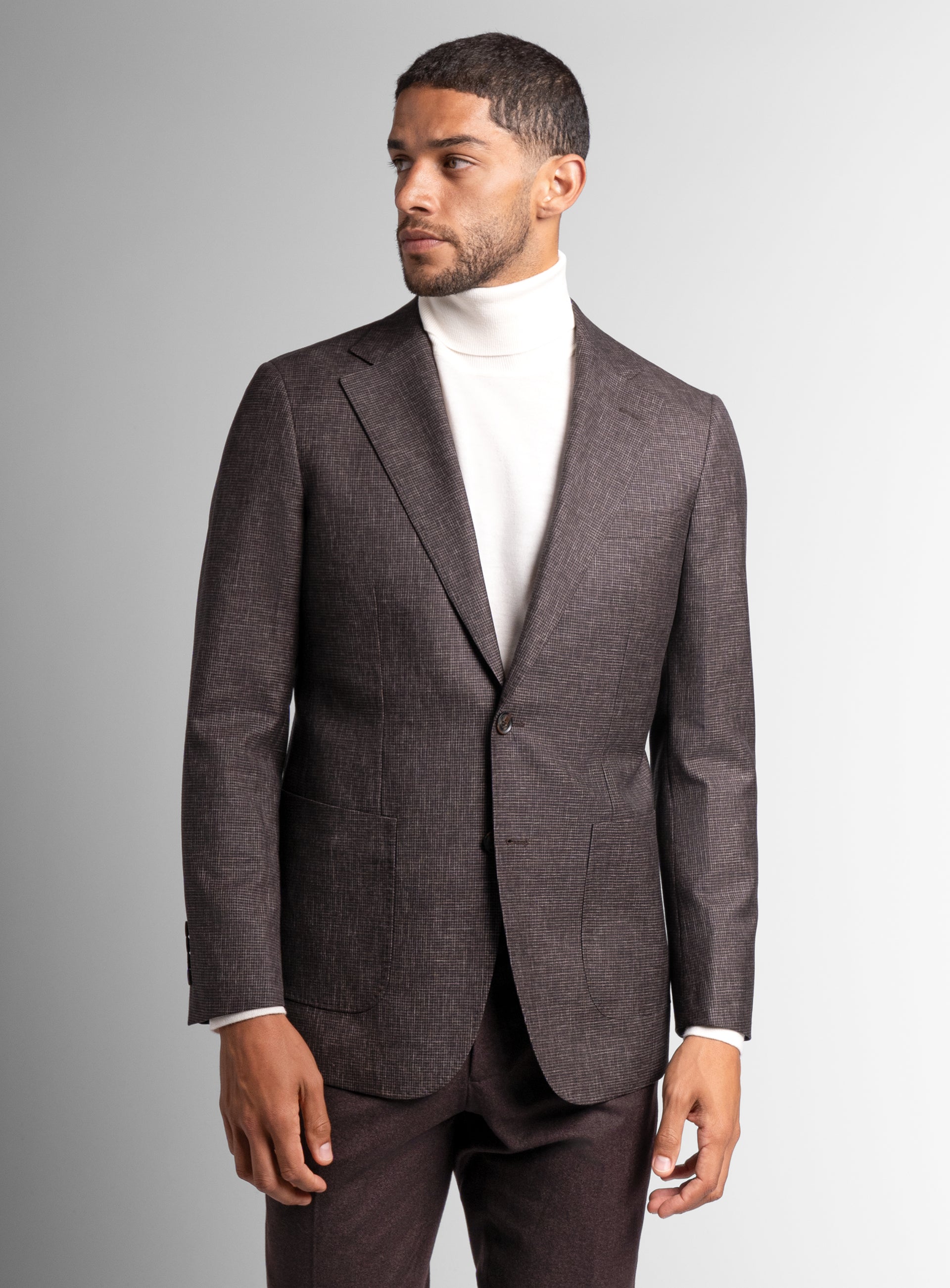 A side-view of the Mondovi Puppytooth Brown Jacket