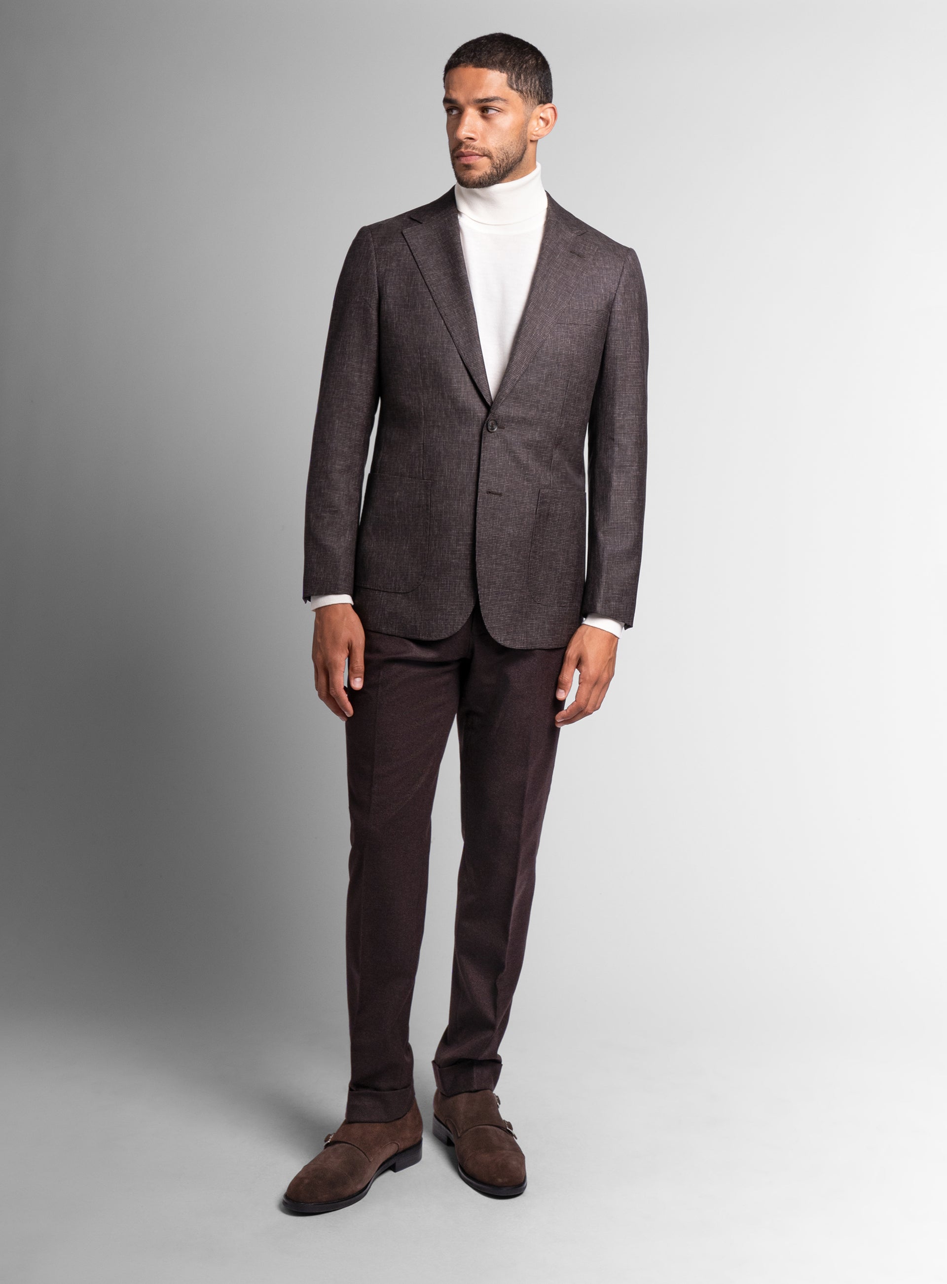 A man wearing the Mondovi Puppytooth Brown Jacket