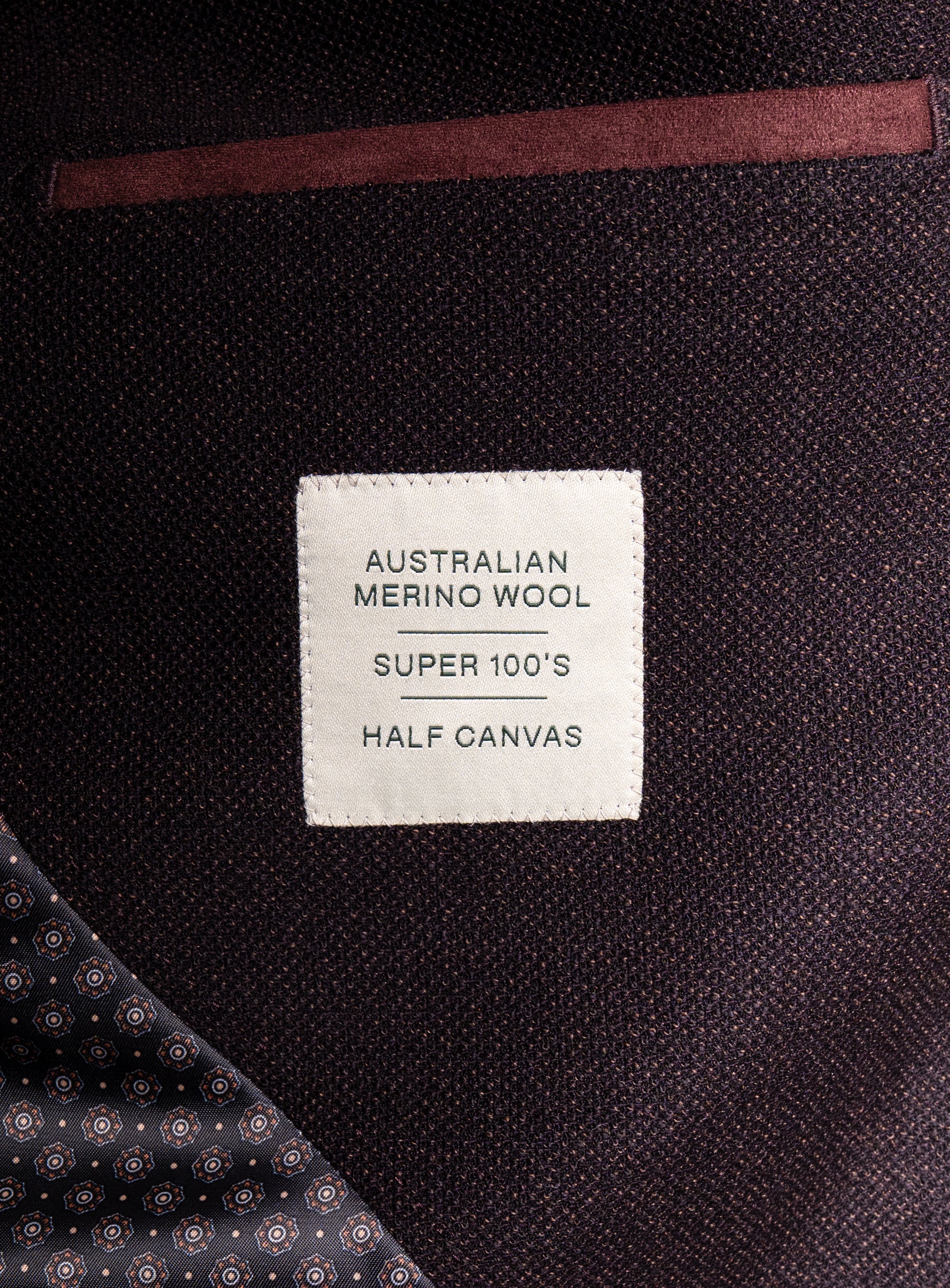 Picture of a label that says "Australian Merino Wool - Super 100's - Half Canvas" on the Vitale Barleycorn Mahogany Red Sport Jacket