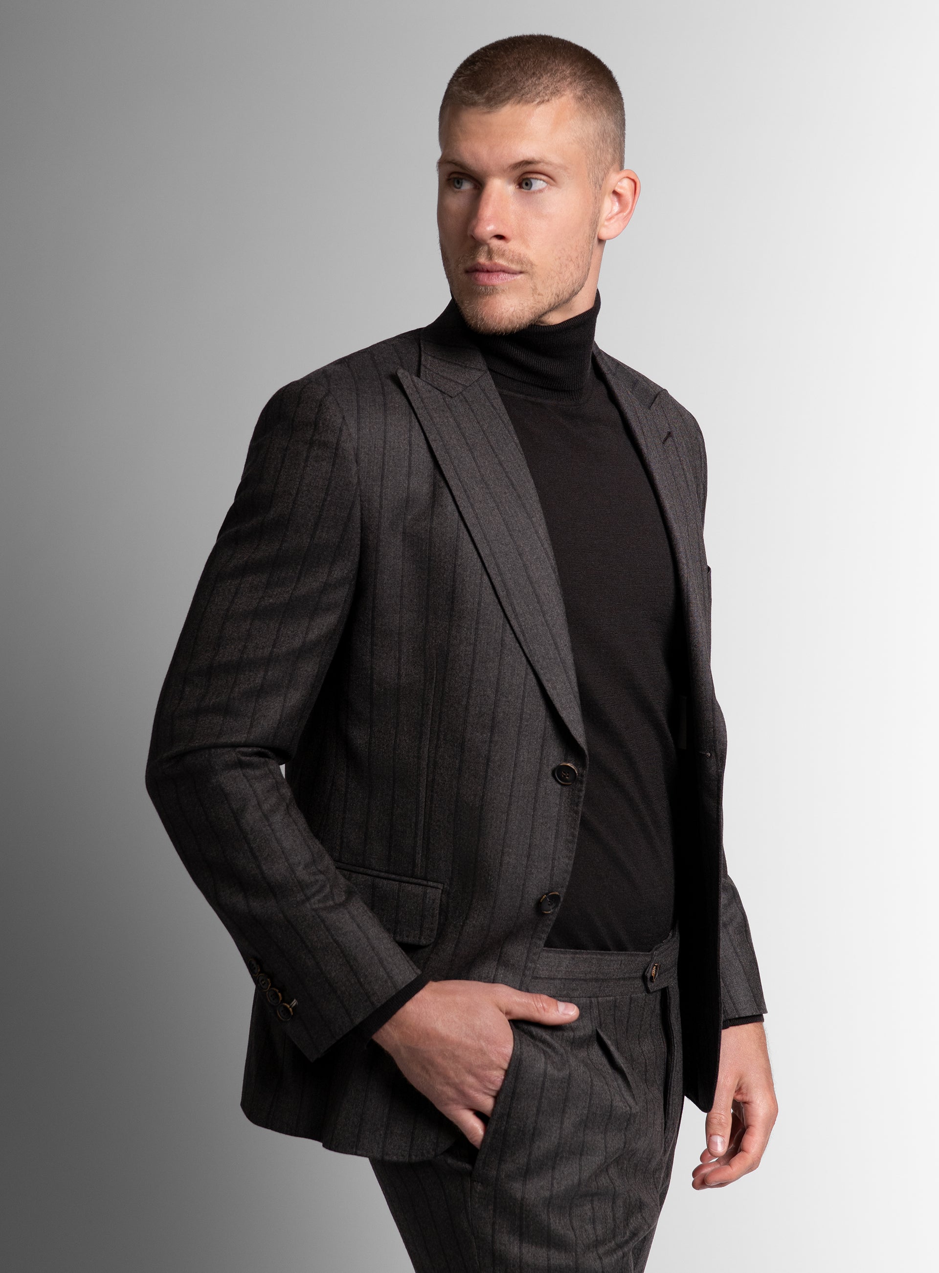 A man looking to his side while wearing the Baroncelli Striped Brown Sport Jacket