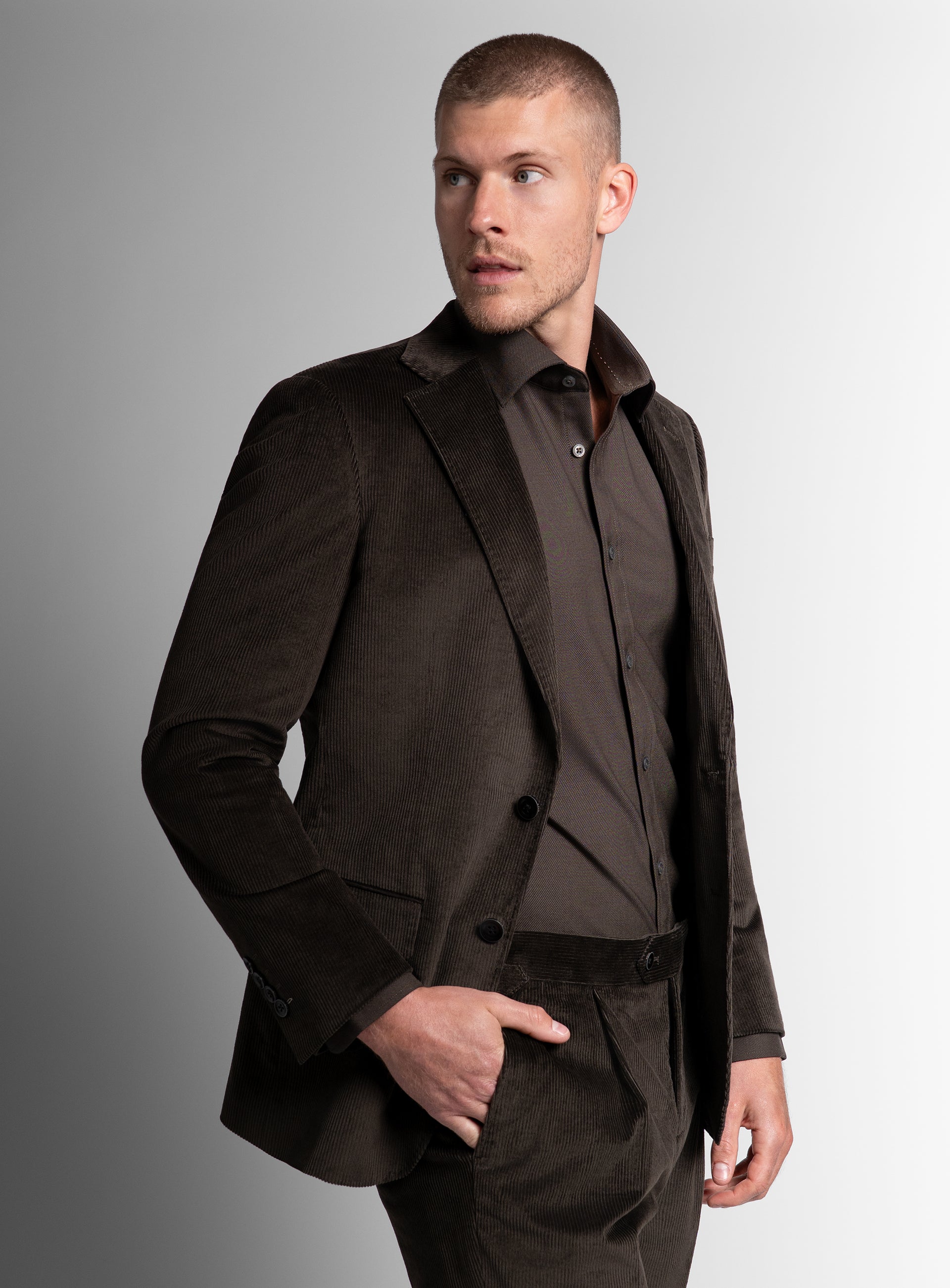 Man looking to his side while wearing the Vitale Corduroy Olive Green Sport Jacket