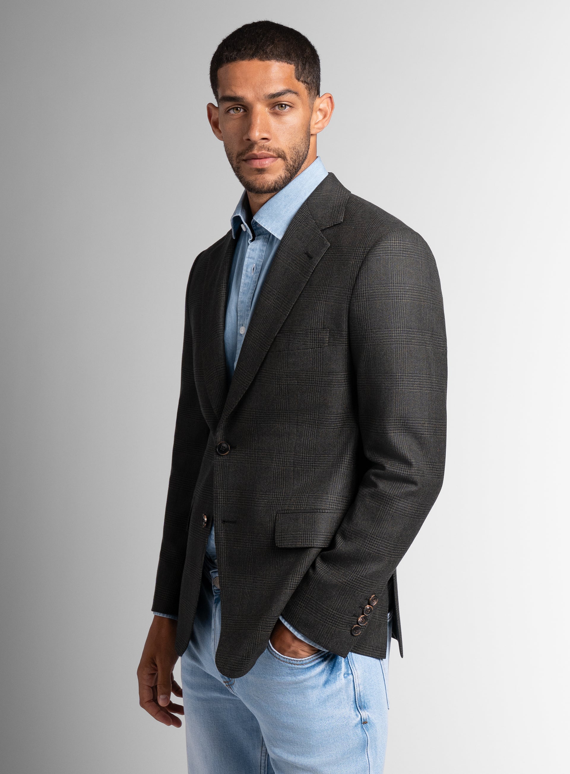 Man standing to the side while wearing the Vito Plaid Olive Green Sport Jacket