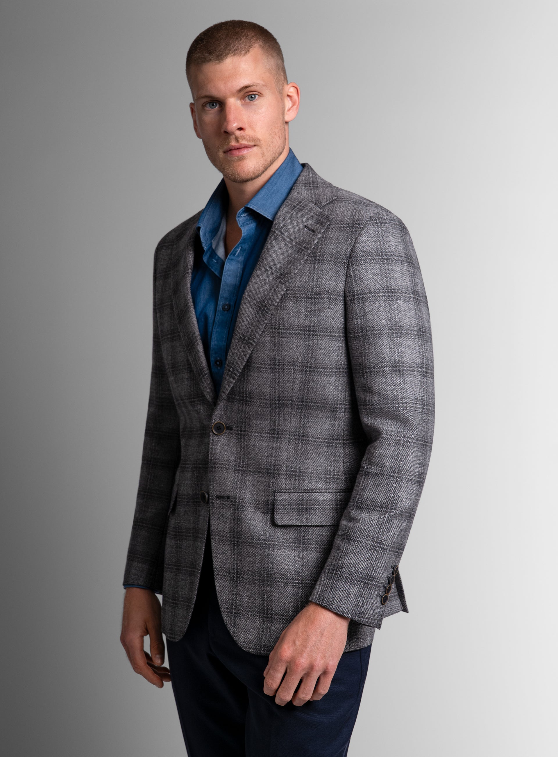Man wearing the Vitale Barleycorn Plaid Grey Sport Jacket standing to his side