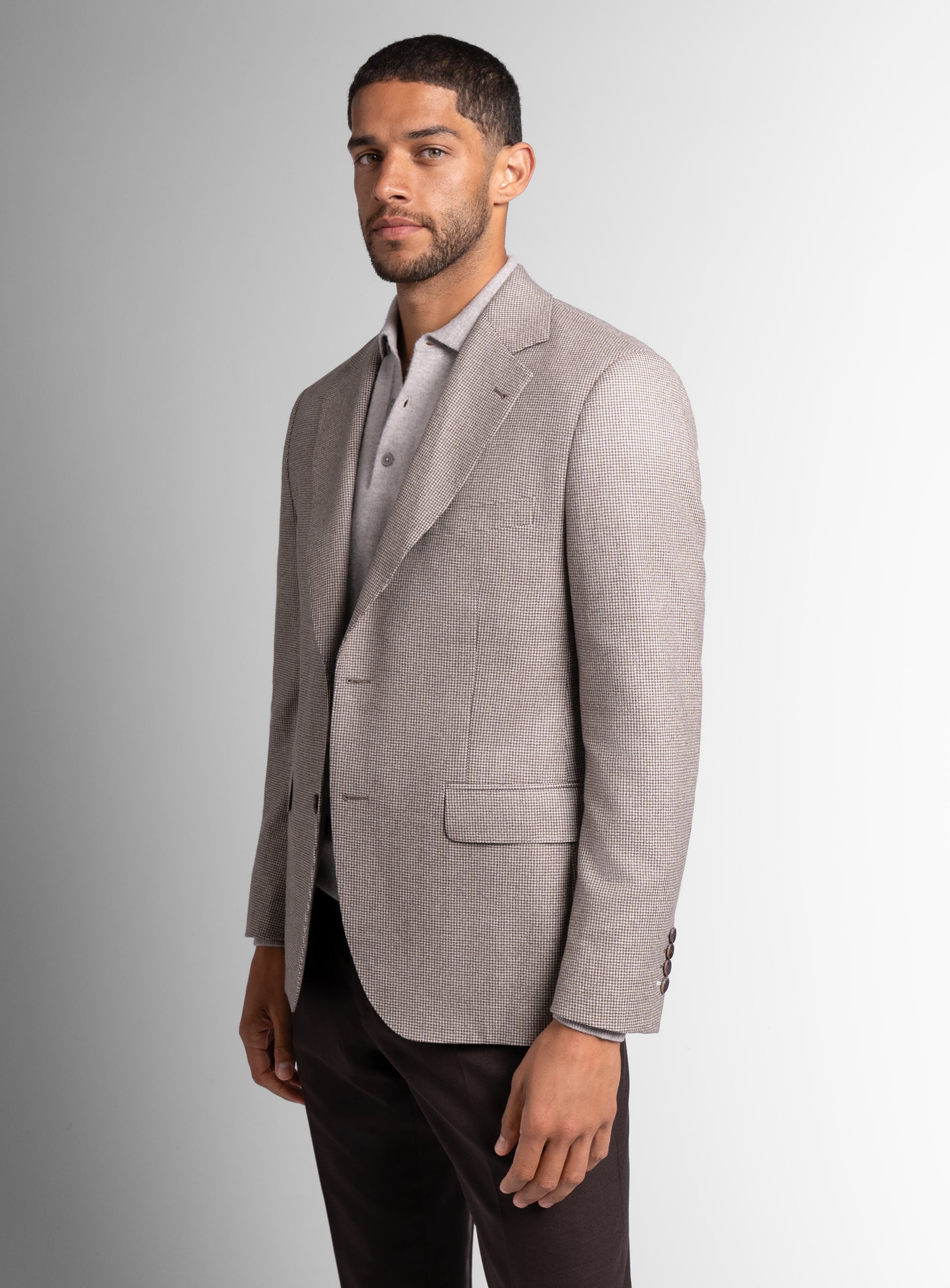 Picture of a man wearing the Vito Puppytooth Taupe Brown Jacket, standing to the side