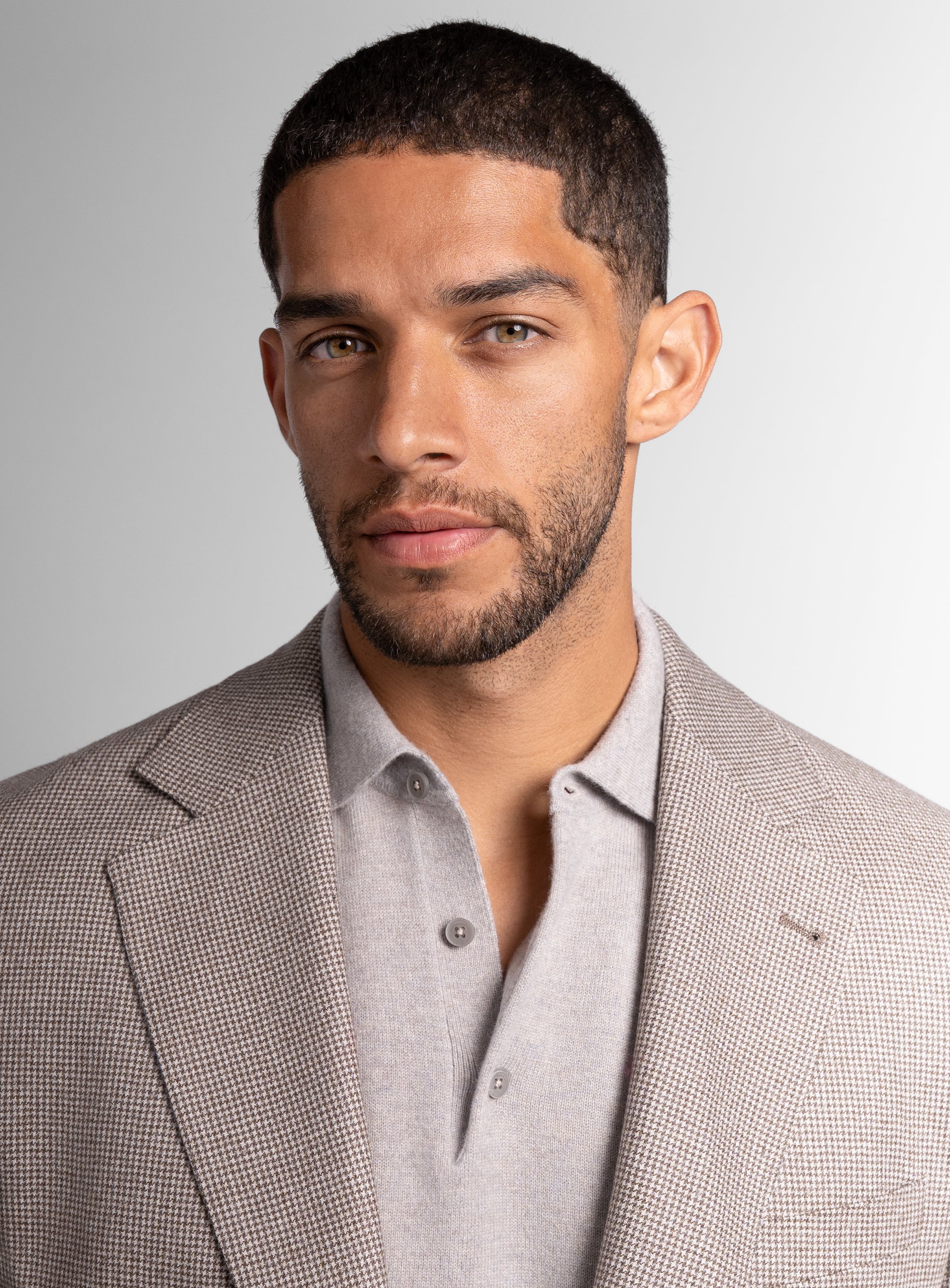 Close-up of a man wearing the Vito Puppytooth Taupe Brown Jacket