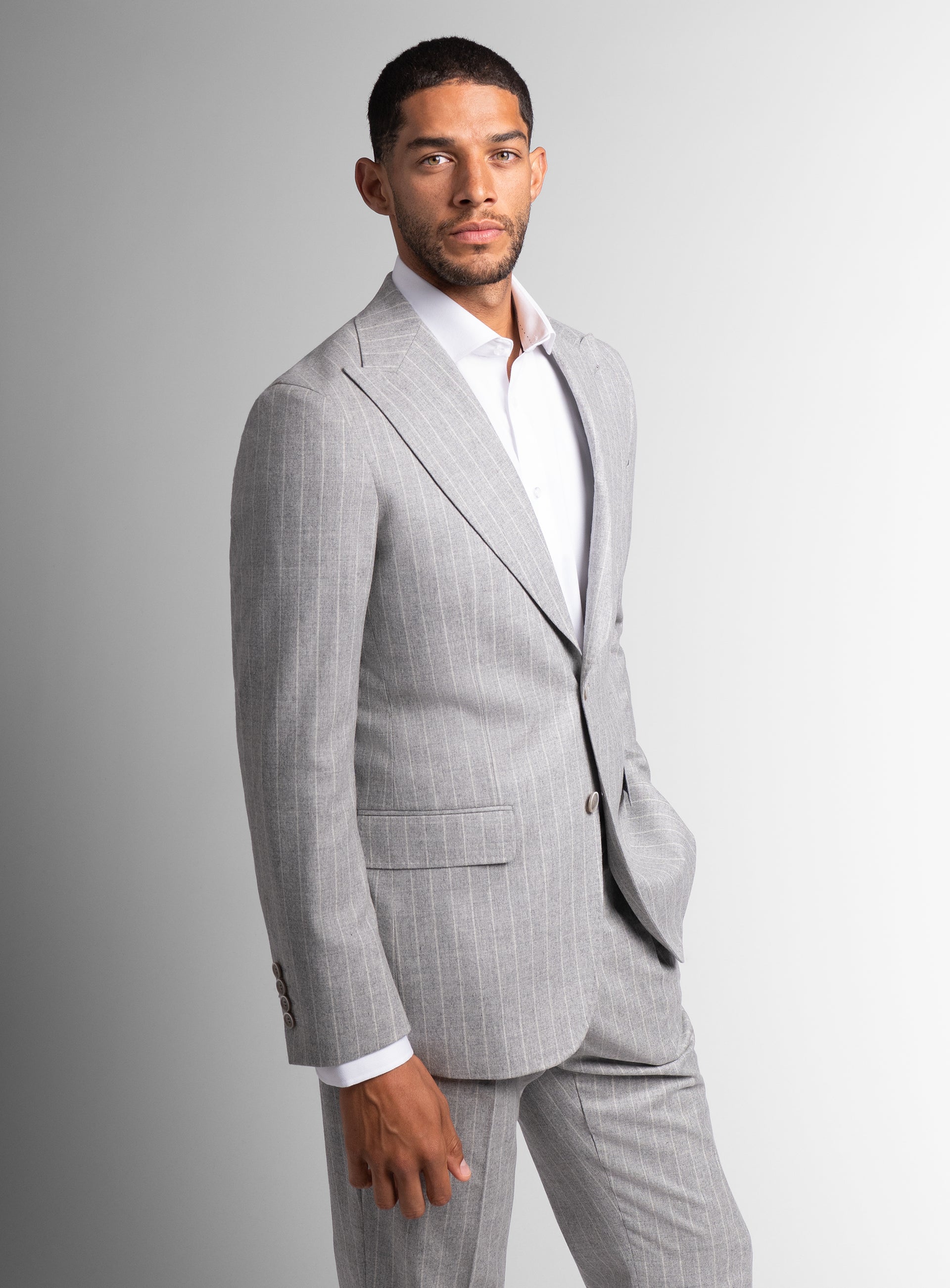 Man to his side wearing the Portici Milled Pinstripe Silver Grey Jacket