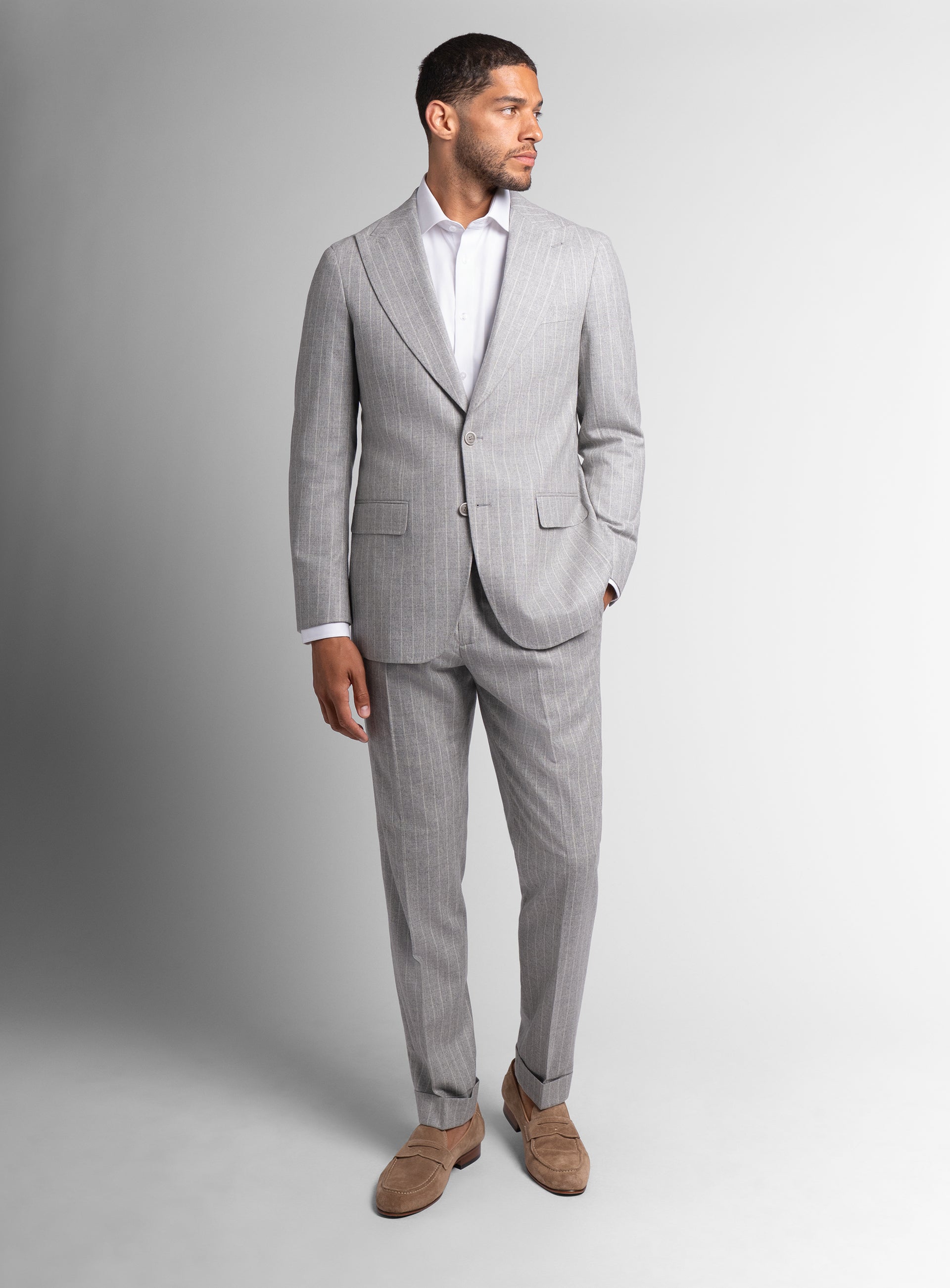 Man looking to his side wearing the Portici Milled Pinstripe Silver Grey Jacket
