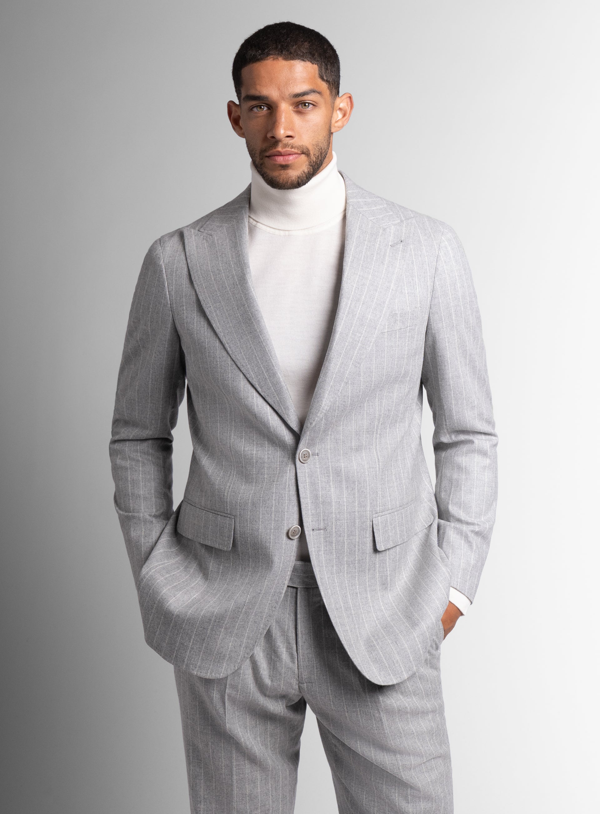 Man wearing the Portici Milled Pinstripe Silver Grey Jacket with both hands in his pockets