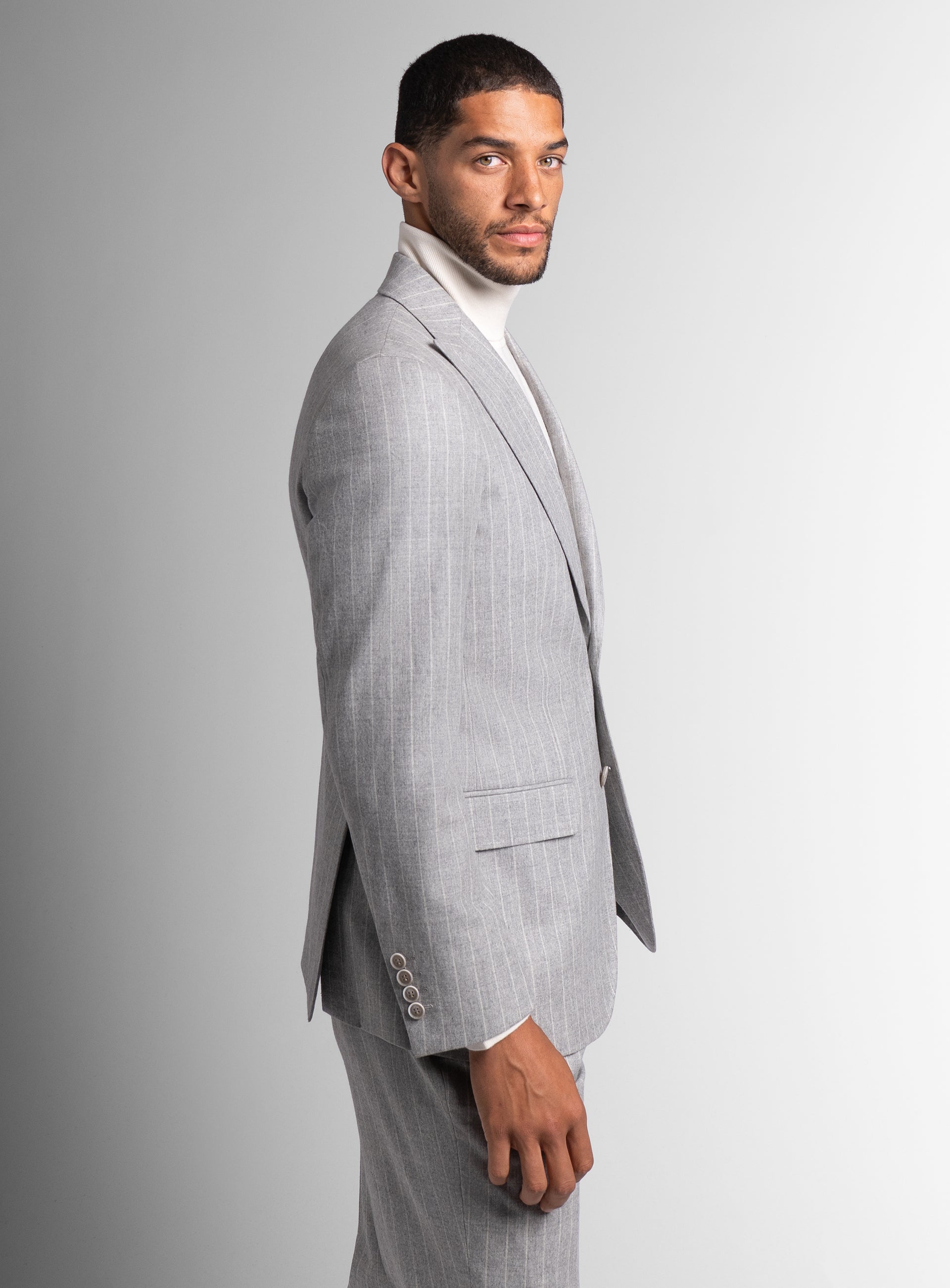Man to his side wearing the Portici Milled Pinstripe Silver Grey Jacket