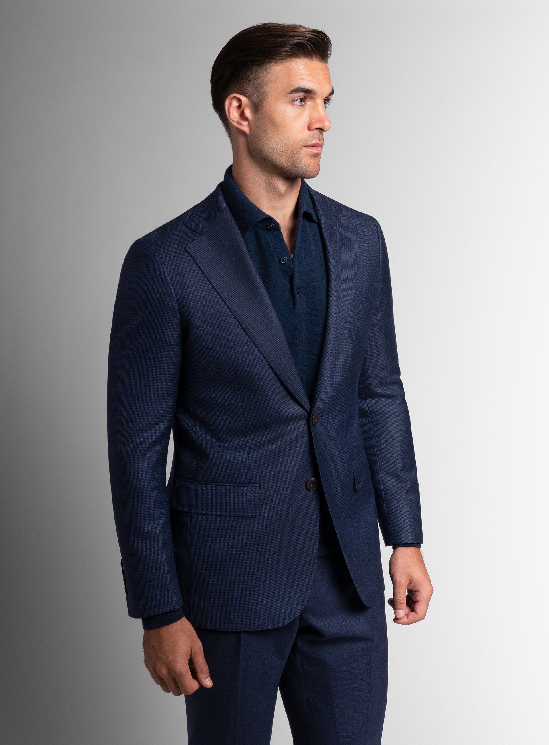 Man looking to his side while wearing the Vitale Puppytooth Navy Sport Jacket