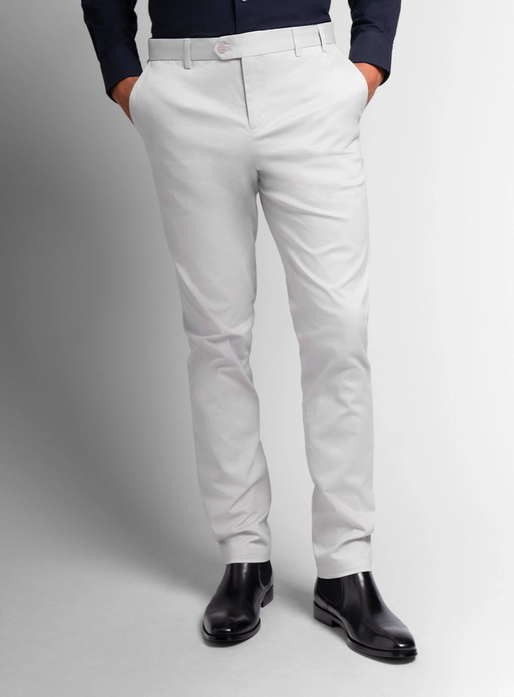 White pants worn by a person on a gray background
