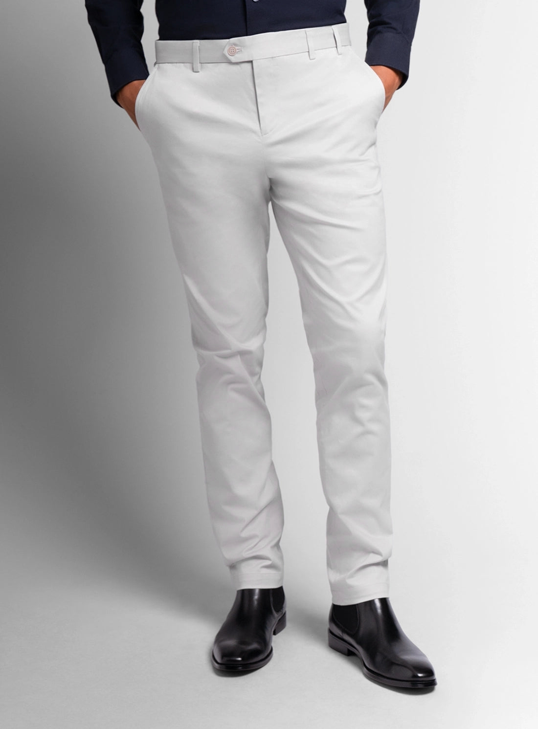 White pants worn by a person on a gray background