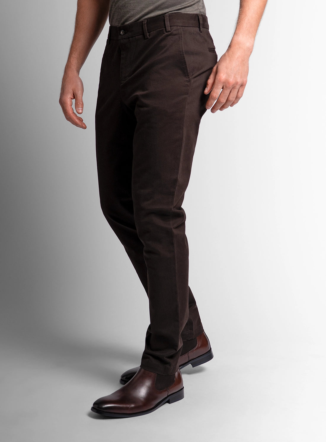 Brown pants worn by a person on a gray background