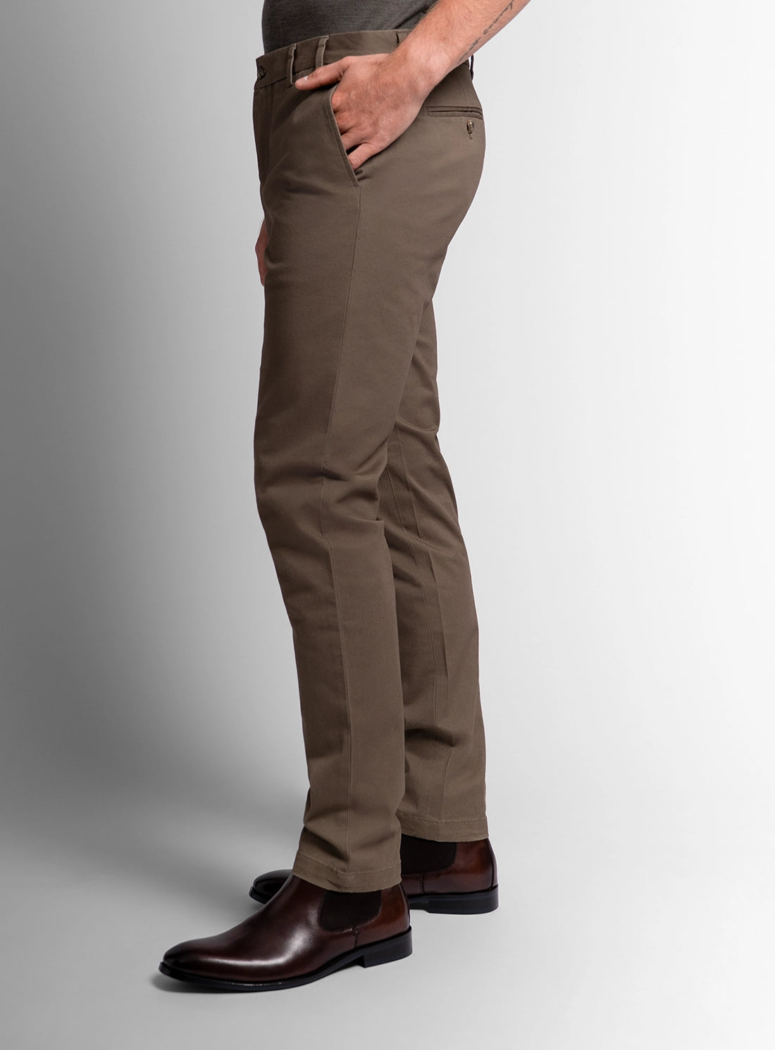 Brown pants worn by a person on a gray background