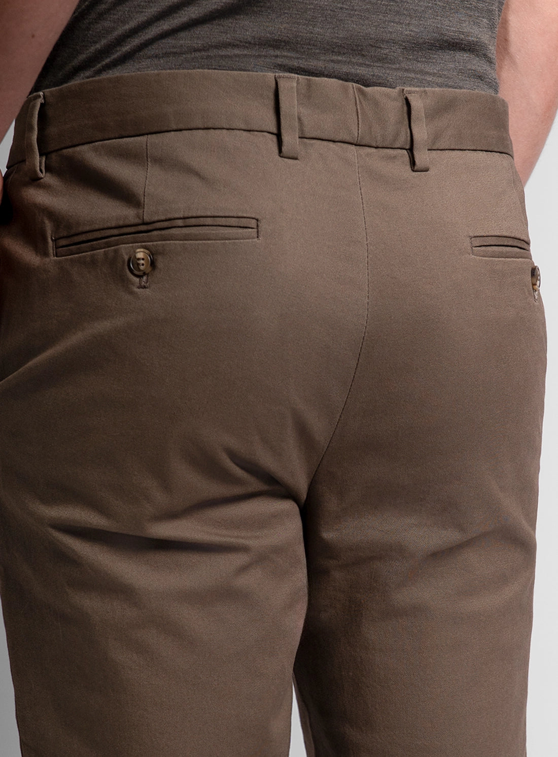 Brown pants with a gray shirt on a white background