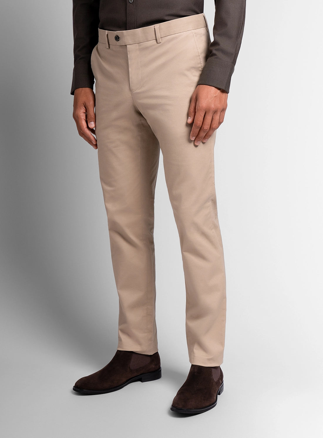 Beige pants worn by a person on a gray background
