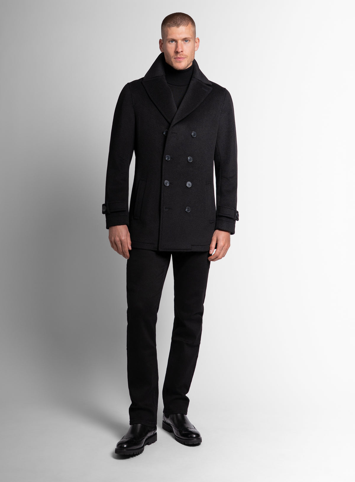 A man wearing the Bridge Black Peacoat