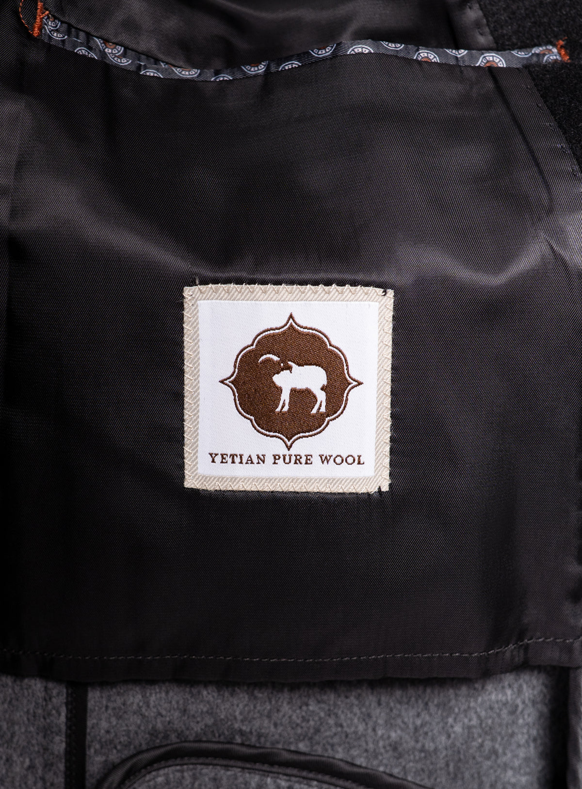 A logo that says "Yetian Pure Wool" on the Bridge Black Peacoat
