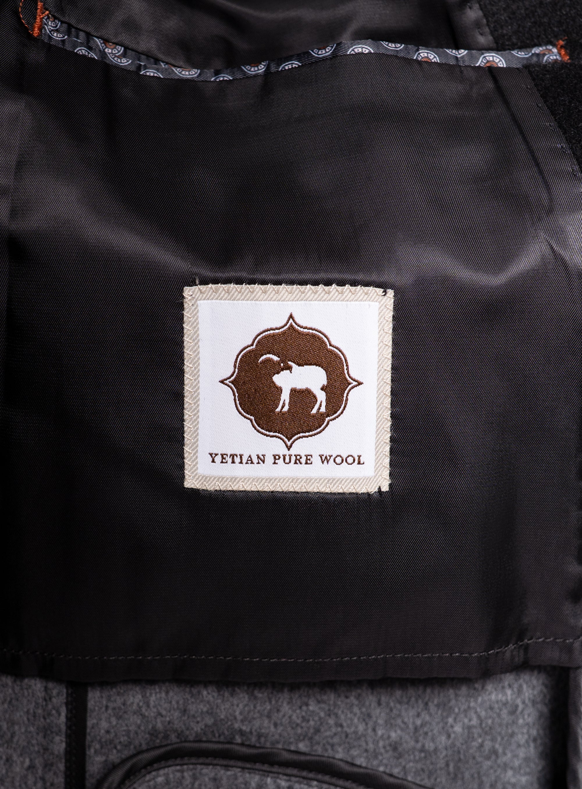 A logo that says "Yetian Pure Wool" on the Bridge Black Peacoat