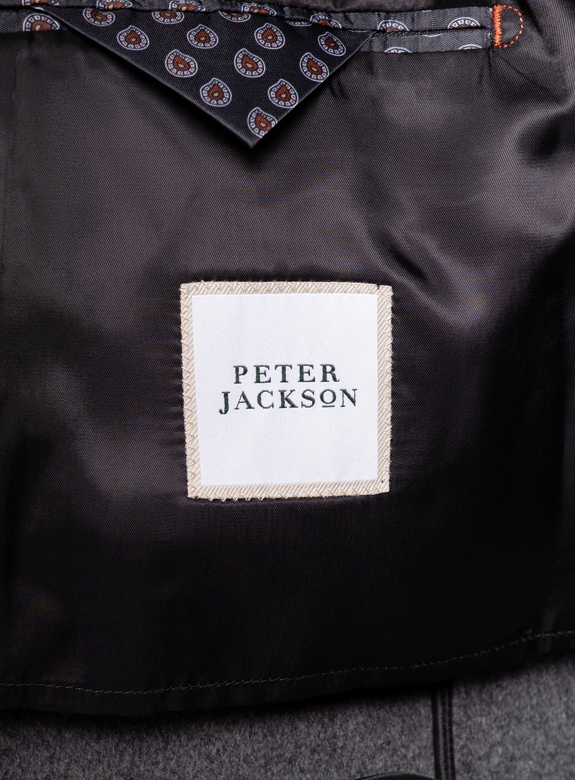 The "Peter Jackson" logo on the Bridge Black Peacoat