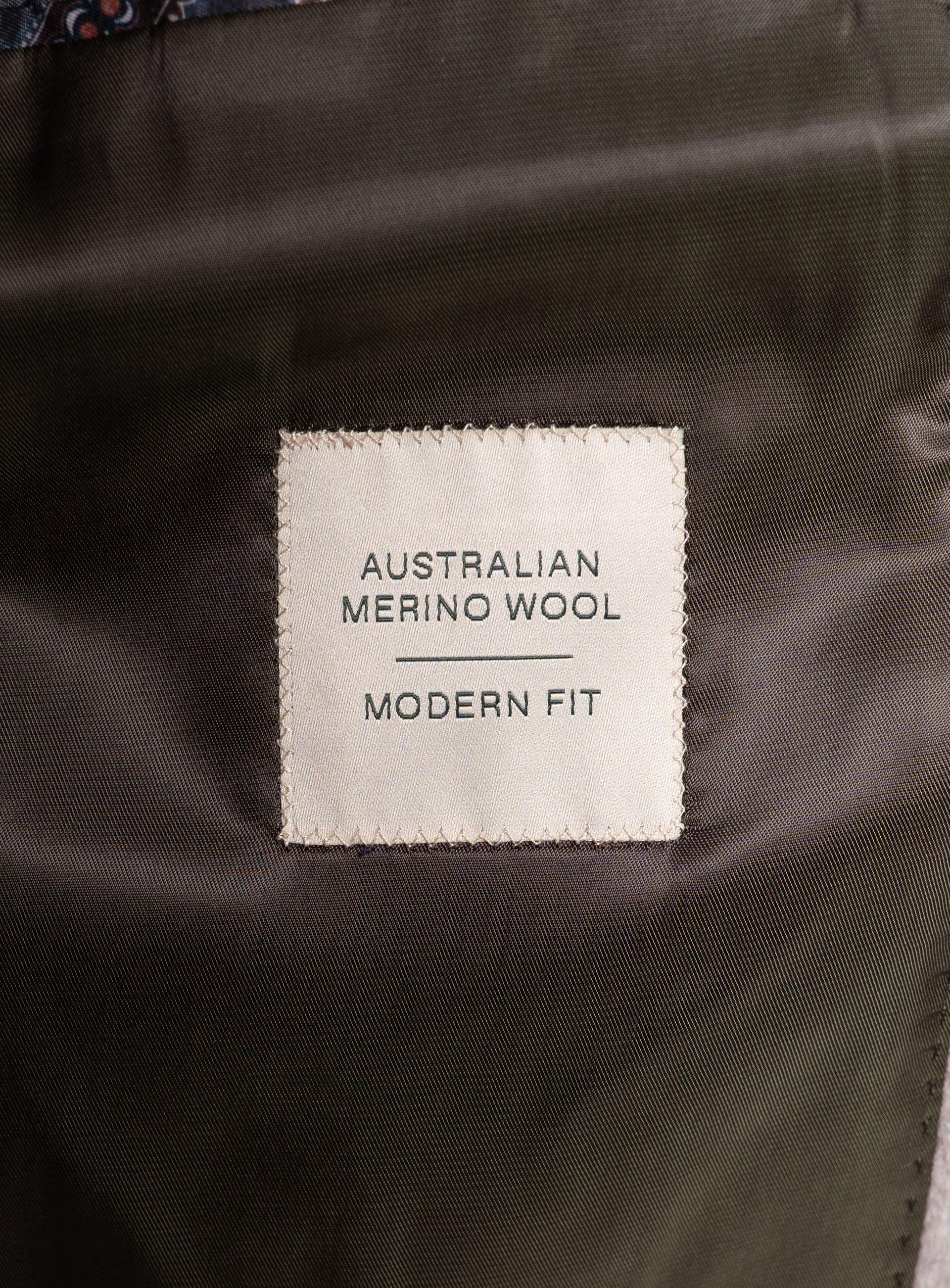 A label that says "Australian Merino Wool - Modern Fit" on the Gallio Wool Pile Forest Green Coat