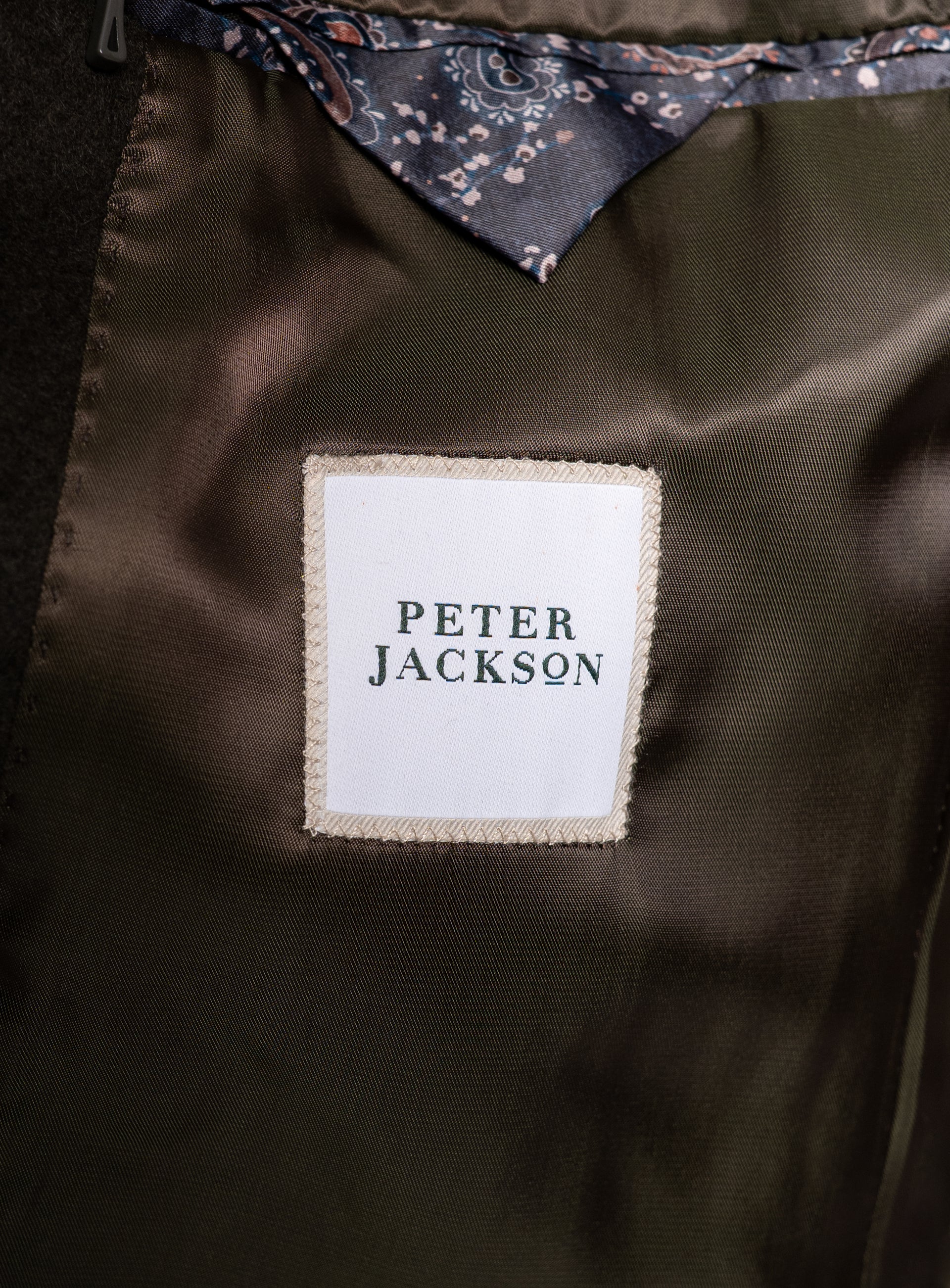 The "Peter Jackson" logo on the Gallio Wool Pile Forest Green Coat