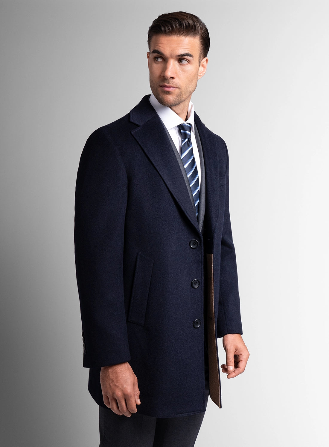 A man looking to his side wearing the Signature Wool Pile Navy Blue Coat